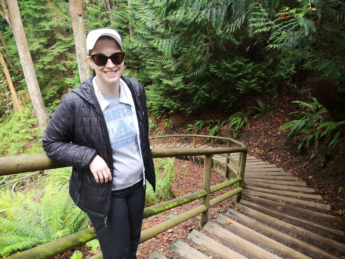 Danielle smiling in North Shore rainforest staircase